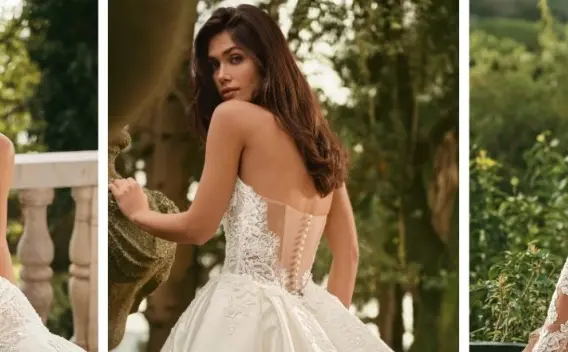 Bride trying on a lace wedding gown with help from a bridal stylist inside an elegant Enzoani boutique during her first bridal appointment.
