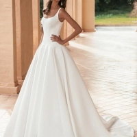 Blue by Enzoani Ulandra luxury satin ballgown wedding dress featuring a scoop neckline, structured bodice and dramatic cathedral train.