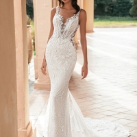Blue by Enzoani Ularia is a luxury fitted mermaid wedding dress featuring an illusion plunge neckline, delicate shoulder straps, intricate beaded lace embroidery and a figure-enhancing silhouette. Designed for brides seeking a glamorous designer wedding go