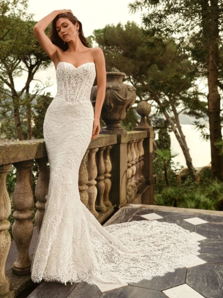 Bride wearing the Enzoani WANDA wedding dress, a romantic strapless lace fit-and-flare bridal gown with an illusion corset bodice without detachable satin overskirt, perfect for luxury, modern, and destination weddings.