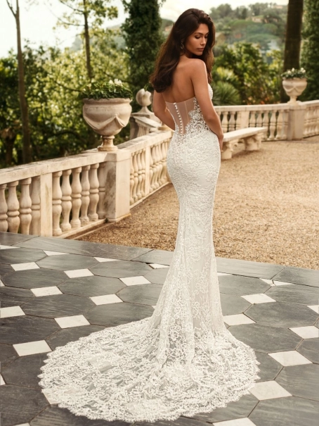 Bride wearing the Enzoani WANDA wedding dress, a romantic strapless lace fit-and-flare bridal gown with an illusion corset bodice without detachable satin overskirt, perfect for luxury, modern, and destination weddings.