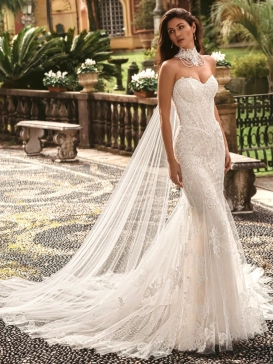 Enzoani luxury wedding dress featuring a romantic mermaid silhouette with intricate floral lace appliqué, fitted sweetheart bodice, illusion detailing and a dramatic cathedral-length tulle train. Designed for modern brides seeking a designer wedding dress