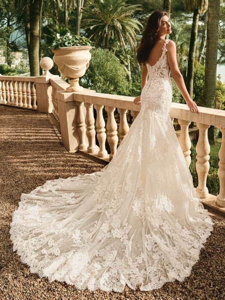 Enzoani Winslet is a luxury mermaid wedding dress featuring intricate floral lace appliqué, illusion corsetry, delicate lace shoulder straps and a softly flared lace train. Designed for brides seeking a fitted designer wedding gown that combines couture cr