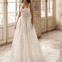 Enzoani Winslow luxury A-line wedding dress featuring floral lace embroidery, square neckline, elegant straps and a flowing cathedral train.