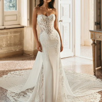 Enzoani Winter is a luxury fitted wedding dress featuring an intricately embroidered illusion corset bodice, sculpted sweetheart neckline, elegant crepe skirt and dramatic detachable lace train. Designed for brides seeking a sophisticated designer wedding