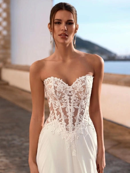 Love Felinna wedding dress by Enzoani featuring an illusion lace corset bodice, detachable off-the-shoulder straps, and a flowing chiffon A-line skirt for romantic elegance.