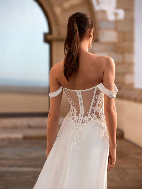 Love Felinna wedding dress by Enzoani featuring an illusion lace corset bodice, detachable off-the-shoulder straps, and a flowing chiffon A-line skirt for romantic elegance.
