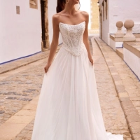 Love by Enzoani FENORA-A is a versatile two-piece designer wedding dress featuring an intricately embellished lace corset bodice paired with a lightweight chiffon A-line skirt. Combining modern bridal fashion with timeless romance, this luxury wedding gown