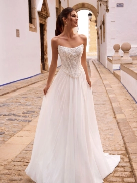 Love by Enzoani FENORA-A is a versatile two-piece designer wedding dress featuring an intricately embellished lace corset bodice paired with a lightweight chiffon A-line skirt. Combining modern bridal fashion with timeless romance, this luxury wedding gown